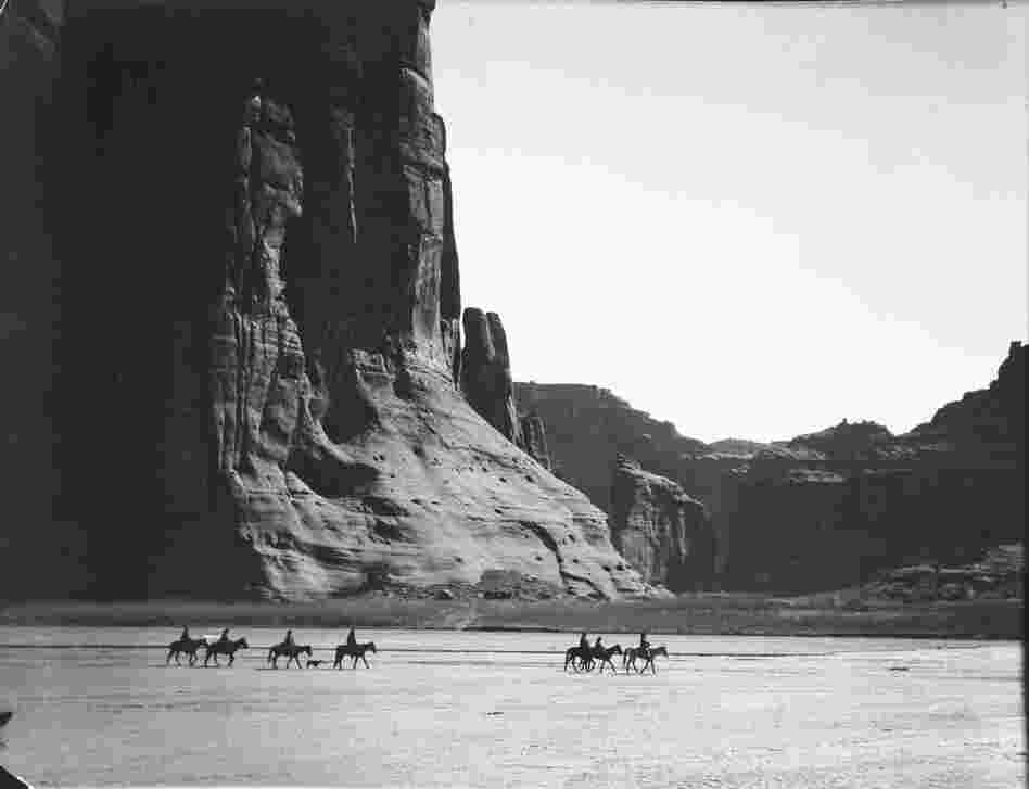 Cañon de Chelly, 1904. In the heart of the Navajo Nation, where stone and sky dwarf humans on horseback, the canyon is one of the most stunning places on Earth.
