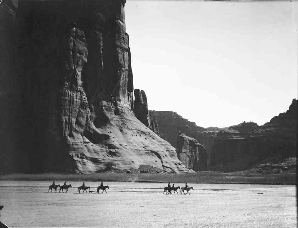 Cañon de Chelly, 1904. In the heart of the Navajo Nation, where stone and sky dwarf humans on horseback, the canyon is one of the most stunning places on Earth.