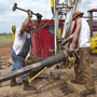 President Obama and Mitt Romney are both calling on the U.S. to become less dependent on foreign oil, though their plans differ. Here, workers with Bramwell Petroleum set up a derrick for a new oil well near Spivey, Kan., in March.