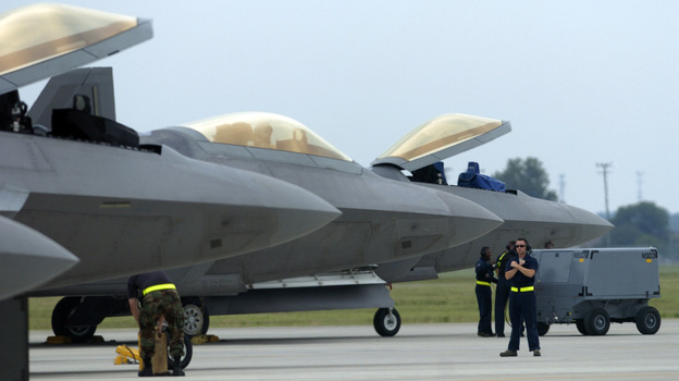 Air Force F-22 Raptors, made by Lockheed Martin, are prepared for flight operations at Langley Air Force Base. Despite the looming defense spending cuts that would go into effect in January if Congress does not pass a deficit reduction plan, Lockheed Martin and other defense contractors announced this week they would not issue layoff notices.