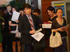 Unemployed Chinese graduates attend a career fair.