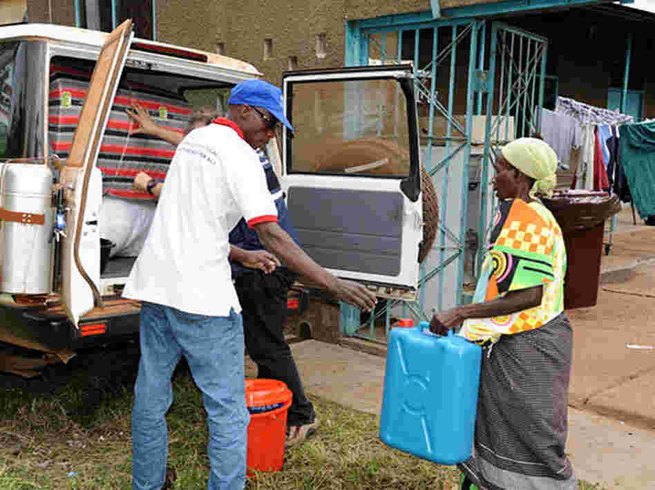 After testing negative for Ebola, Magdalena Nyamurungi returns home with a new set of belongings from the World Health Organization. Medical workers burned and buried her possessions when they suspected she was infected.