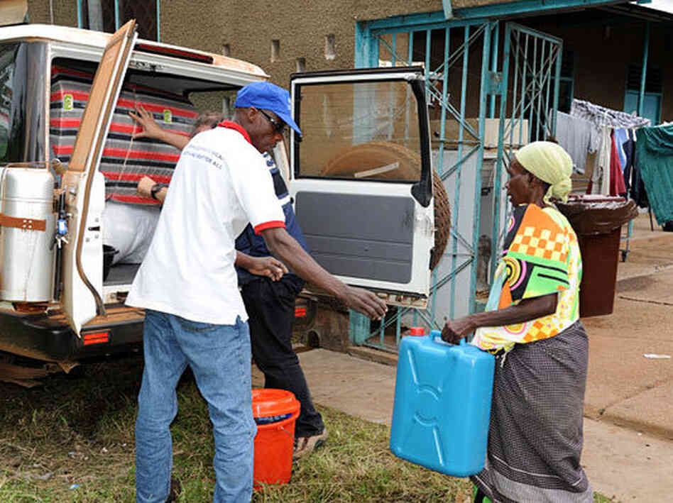 After testing negative for Ebola, Magdalena Nyamurungi returns home with a new set of belongings from the World Health Organization. Medical workers burned and buried her possessions when they suspected she was infected.