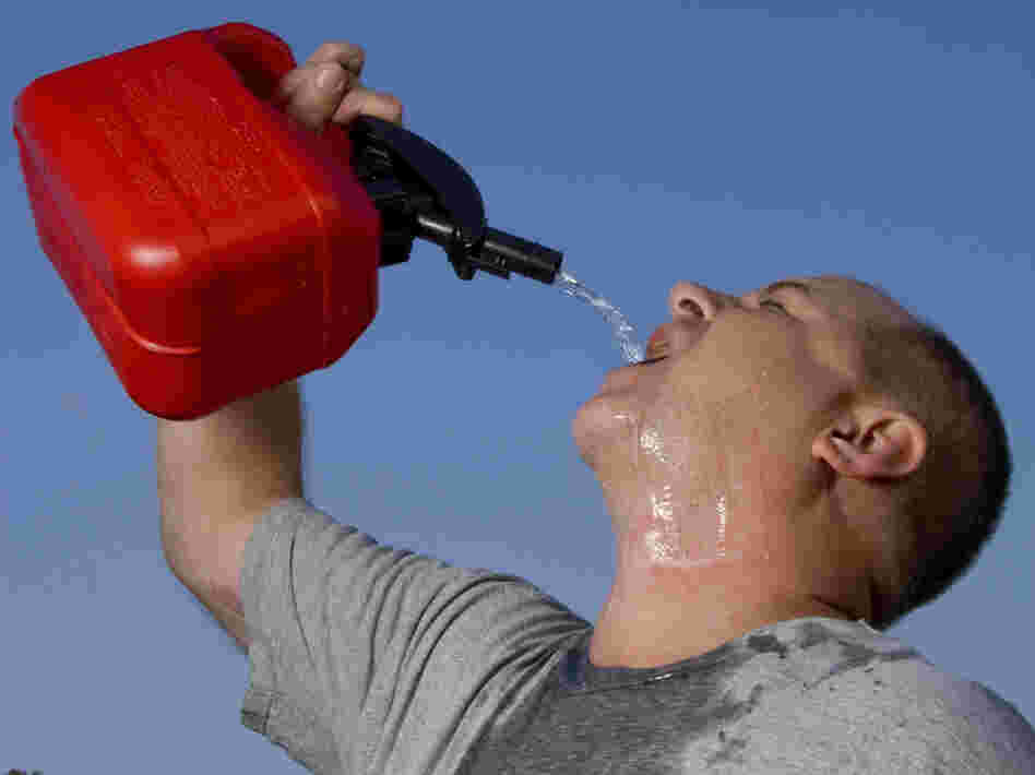 A man drinking gasoline from a gas can.
