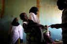 Women and their children wait for medication and instructions on how to use it at the clinic in Dareta, Nigeria. Treating children with high levels of lead is a painstaking process that works only if their environment at home is free from lead.