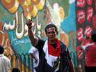 An Egyptian man waves a bullet casing in front of a mural that was painted on a recently whitewashed wall in Tahrir Square in Cairo. An Egyptian man waves a bullet casing in front of a mural that was painted on a recently whitewashed wall in Tahrir Square in Cairo.