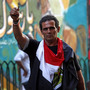 An Egyptian man waves a bullet casing in front of a mural that was painted on a recently whitewashed wall in Tahrir Square in Cairo. An Egyptian man waves a bullet casing in front of a mural that was painted on a recently whitewashed wall in Tahrir Square in Cairo.