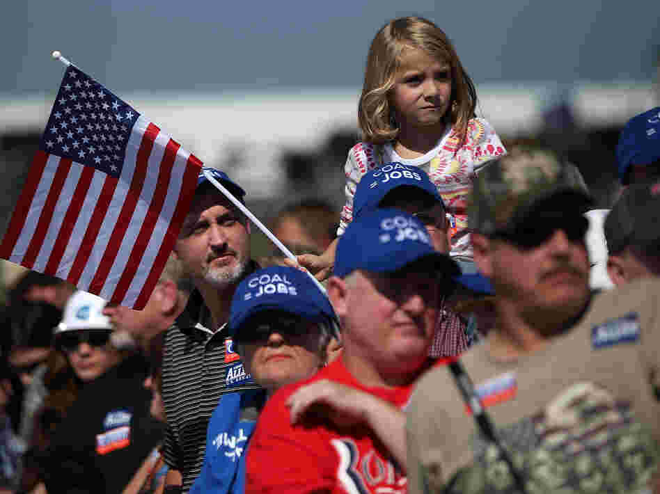 Supporters watch Republican presidential candidate Mitt Romney speak on Friday in Abingdon, Va. Romney started off his campaign calling for big tax cuts, but has backed off that somewhat.