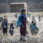 Afghan children run to school on Sept. 24. Whoever takes over as the next U.S. president will have to determine how many troops will remain after the December 2014 deadline to help with long-term security.