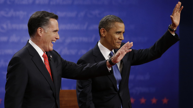 Mitt Romney and President  Obama wave to the audience during the first presidential debate at the University of Denver, on Wednesday.