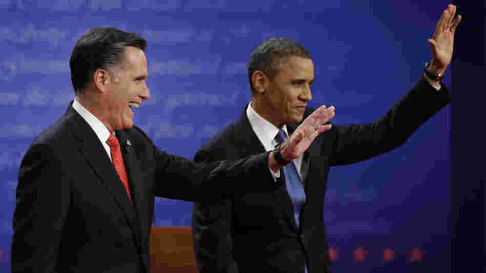 Mitt Romney and President  Obama wave to the audience during the first presidential debate at the University of Denver, on Wednesday.