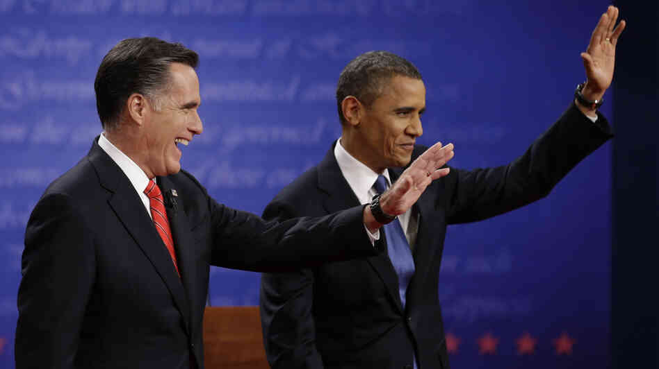 Mitt Romney and President  Obama wave to the audience during the first presidential debate at the University of Denver, on Wednesday.