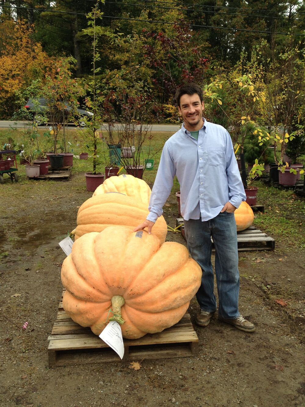 Topher Mallory stands next to the pumpkin he turned into a first-place-winning powerboat.