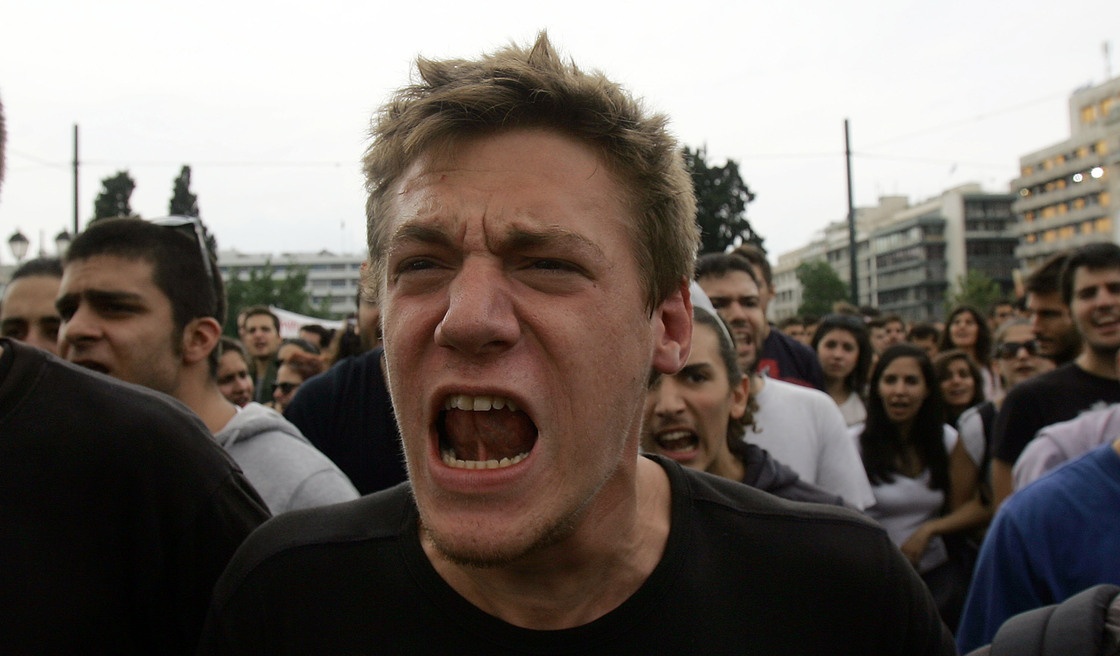 Demonstrators shout slogans during a protest against German Chancellor Angela Merkel's visit to Greece on Tuesday.