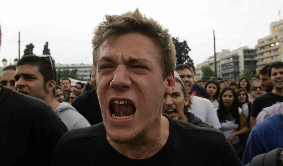 Demonstrators shout slogans during a protest against German Chancellor Angela Merkel's visit to Greece on Tuesday.