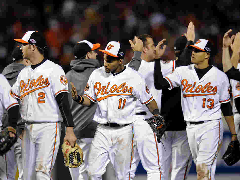 Baltimore Orioles Nate McLouth (from left), J.J. Hardy, Robert Andino and Manny Machado high-five teammates after Game 2 of Major League Baseball's American League Division Series against the New York Yankees. Somewhere, commentator and Orioles fan Frank Deford is also giving high-fives.