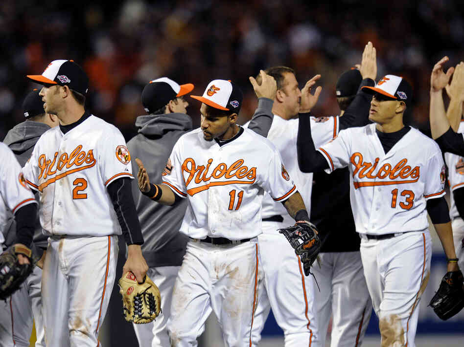 Baltimore Orioles Nate McLouth (from left), J.J. Hardy, Robert Andino and Manny Machado high-five teammates after Game 2 of Major League Baseball's American League Division Series against the New York Yankees. Somewhere, commentator and Orioles fan Frank Deford is also giving high-fives.