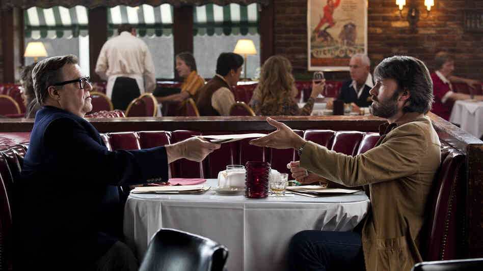 John Chambers (John Goodman) serves as a guide to the ins and outs of the movie business for CIA agent Tony Mendez (Ben Affleck). John Chambers (John Goodman) serves as a guide to the ins and outs of the movie business for CIA agent Tony Mendez (Ben Affleck).