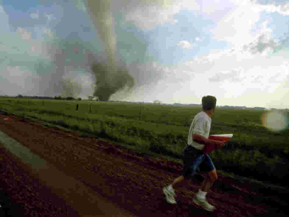 A storm chaser (a kind of weather scientist) places a probe in the path of a tornado in South Dakota.