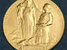 The medal for the Nobel in Physics. According to the Nobel committee, the inscription reads: " 'Inventas vitam juvat excoluisse per artes' loosely translated 'And they who bettered life on earth by their newly found mastery.' "