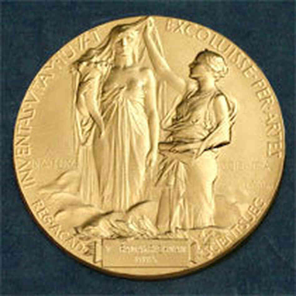 The medal for the Nobel in Physics. According to the Nobel committee, the inscription reads: " 'Inventas vitam juvat excoluisse per artes' loosely translated 'And they who bettered life on earth by their newly found mastery.' " The medal for the Nobel in Physics. According to the Nobel committee, the inscription reads: " 'Inventas vitam juvat excoluisse per artes' loosely translated 'And they who bettered life on earth by their newly found mastery.' "