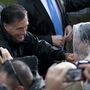 Republican presidential candidate Mitt Romney shakes hands during a rainy campaign rally Monday in Newport News, Va. Republican presidential candidate Mitt Romney shakes hands during a rainy campaign rally Monday in Newport News, Va.