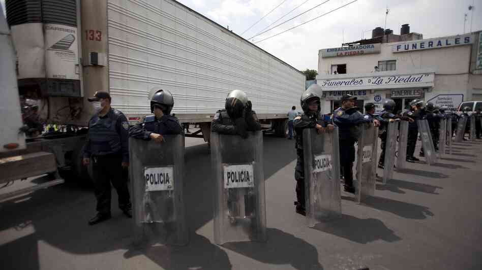 Sept. 1, 2010: Police stood guard by a truck containing some of the bodies of immigrants killed by members of the Zetas drug cartel in Tamaulipas state. Sept. 1, 2010: Police stood guard by a truck containing some of the bodies of immigrants killed by members of the Zetas drug cartel in Tamaulipas state.