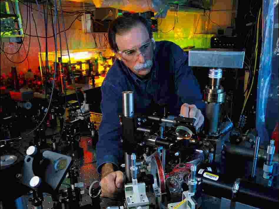 NIST physicist and Nobel Prize-winner David Wineland adjusts an ultraviolet laser beam used to manipulate ions in a high-vacuum apparatus containing an "ion trap." These devices have been used to demonstrate the basic operations required for a quantum computer.