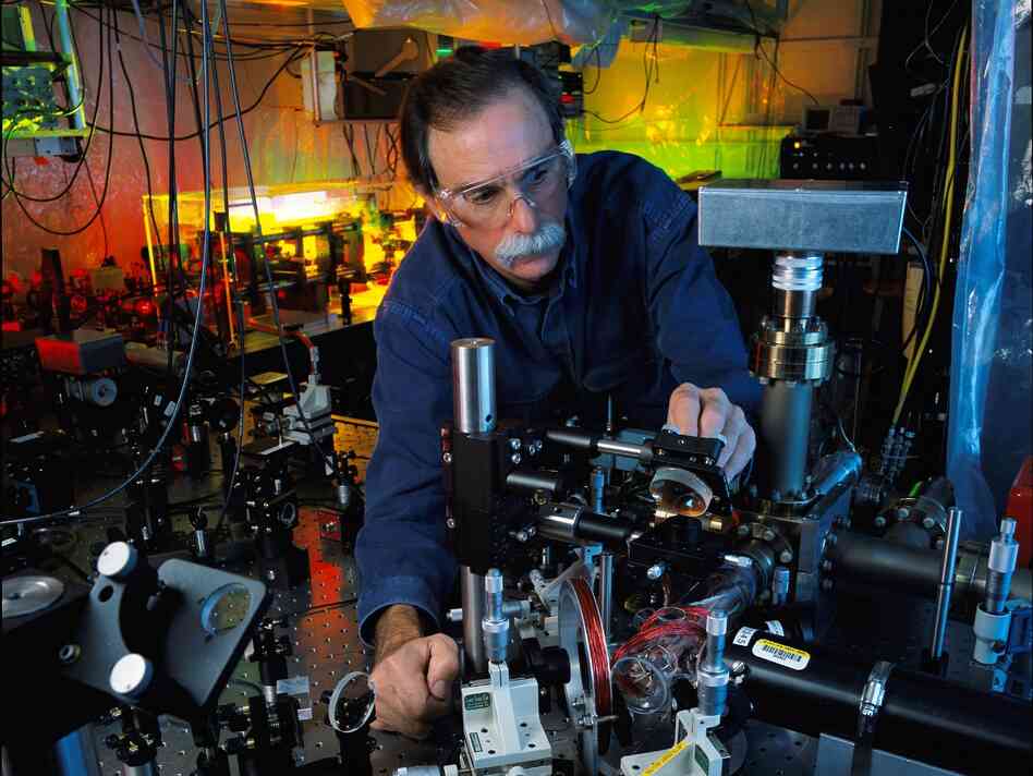 NIST physicist and Nobel Prize-winner David Wineland adjusts an ultraviolet laser beam used to manipulate ions in a high-vacuum apparatus containing an "ion trap." These devices have been used to demonstrate the basic operations required for a quantum computer.