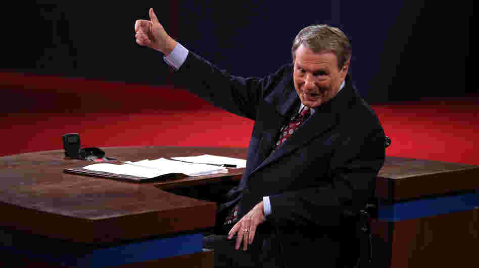 Moderator Jim Lehrer gestures before the presidential debate at the University of Denver last week. Moderators must finagle answers out of sometimes-dodgy politicians and keep control, all without seeming to get in the way.