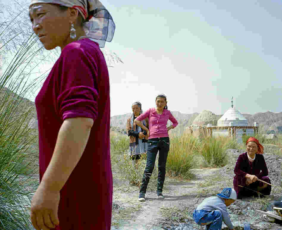 Barukuli, the youngest daughter of the Kuruman family (second from left), and relatives gather for the one-year anniversary of her brother's death, who was 10 years old when he died.
