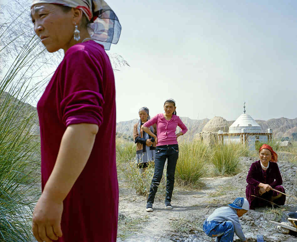 Barukuli, the youngest daughter of the Kuruman family (second from left), and relatives gather for the one-year anniversary of her brother's death, who was 10 years old when he died.