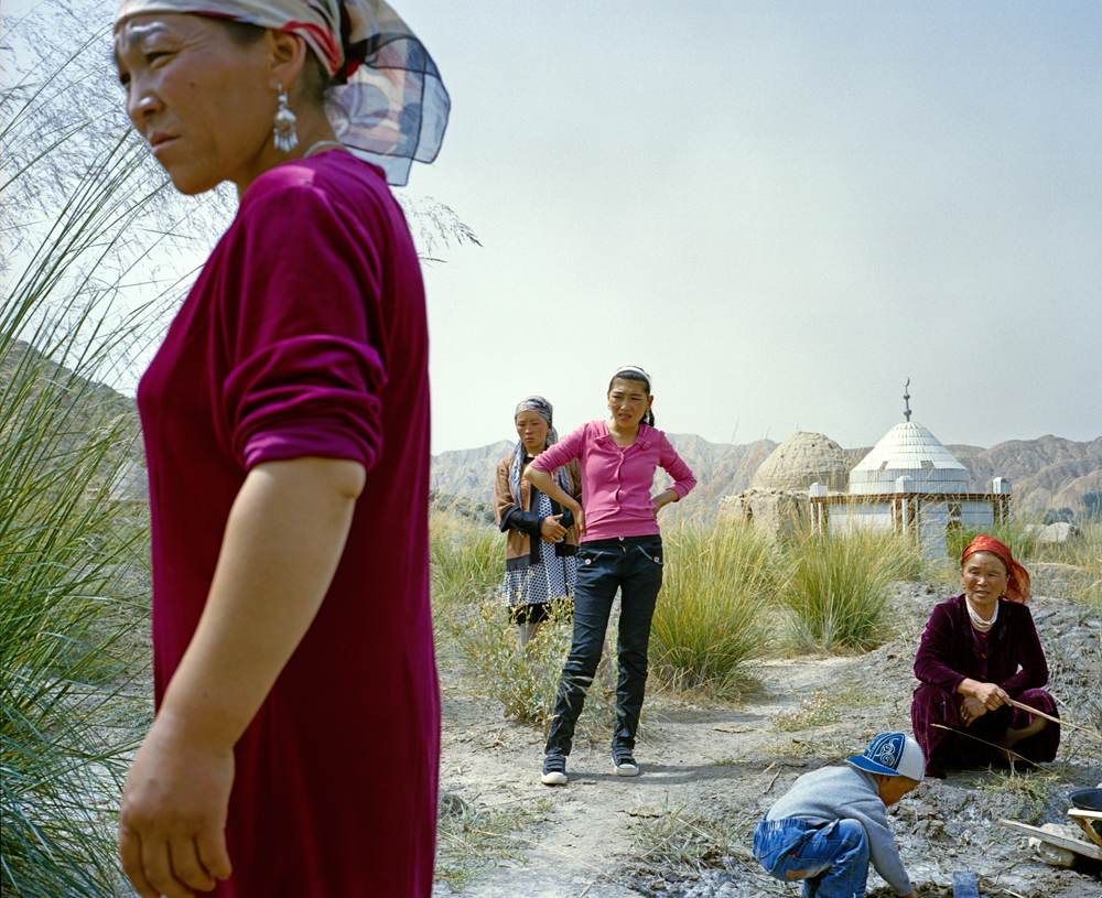 Barukuli, the youngest daughter of the Kuruman family (second from left), and relatives gather for the one-year anniversary of her brother's death, who was 10 years old when he died.
