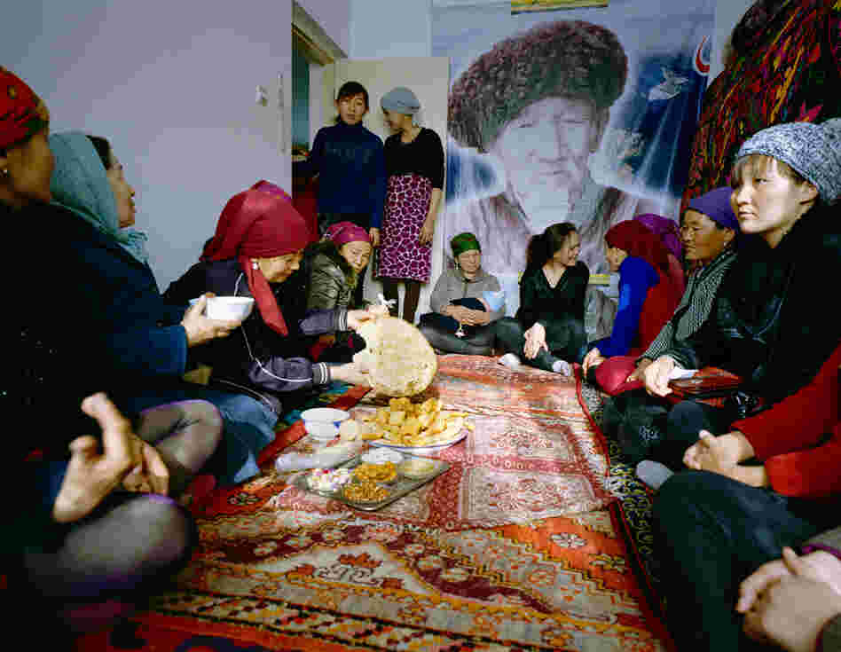 Usunai, the Kuruman family matriarch (center), celebrates a family wedding. The ceremony takes place in a two-bedroom apartment in a newly constructed compound in Wuqiaxian — according to Takayama, a quickly expanding town along a planned highway.