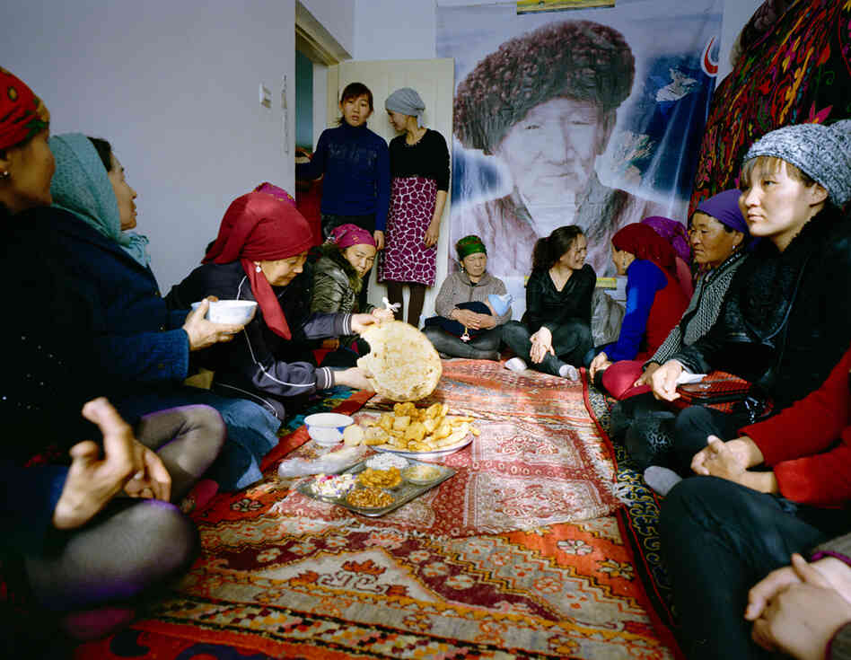 Usunai, the Kuruman family matriarch (center), celebrates a family wedding. The ceremony takes place in a two-bedroom apartment in a newly constructed compound in Wuqiaxian — according to Takayama, a quickly expanding town along a planned highway.