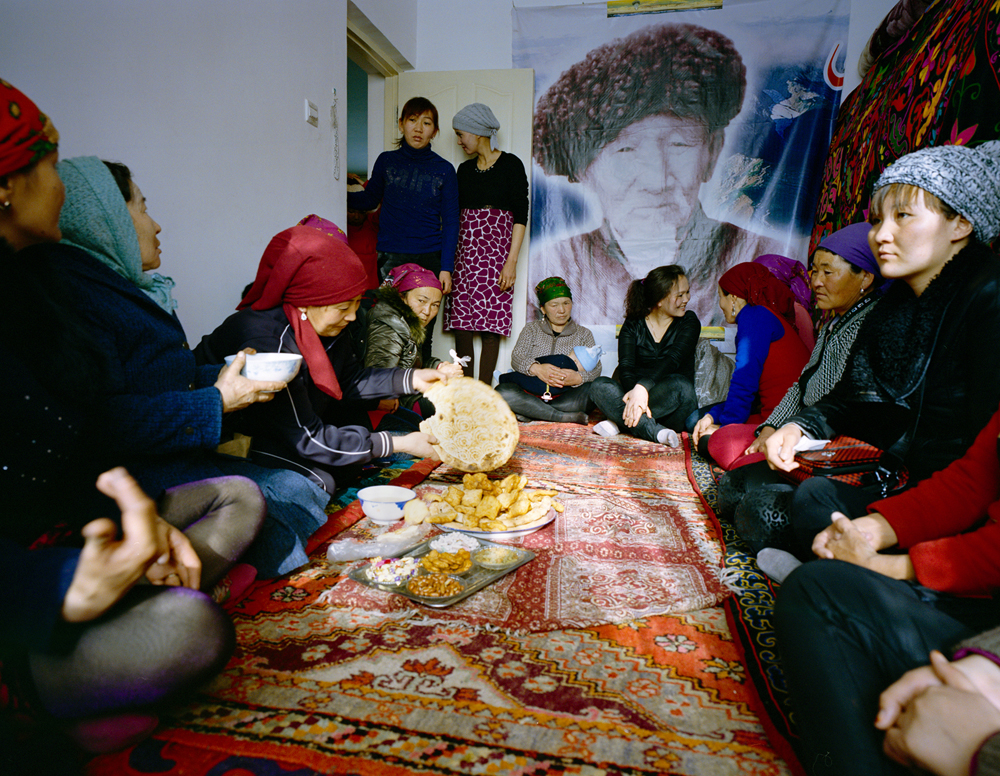 Usunai, the Kuruman family matriarch (center), celebrates a family wedding. The ceremony takes place in a two-bedroom apartment in a newly constructed compound in Wuqiaxian -- according to Takayama, a quickly expanding town along a planned highway.
