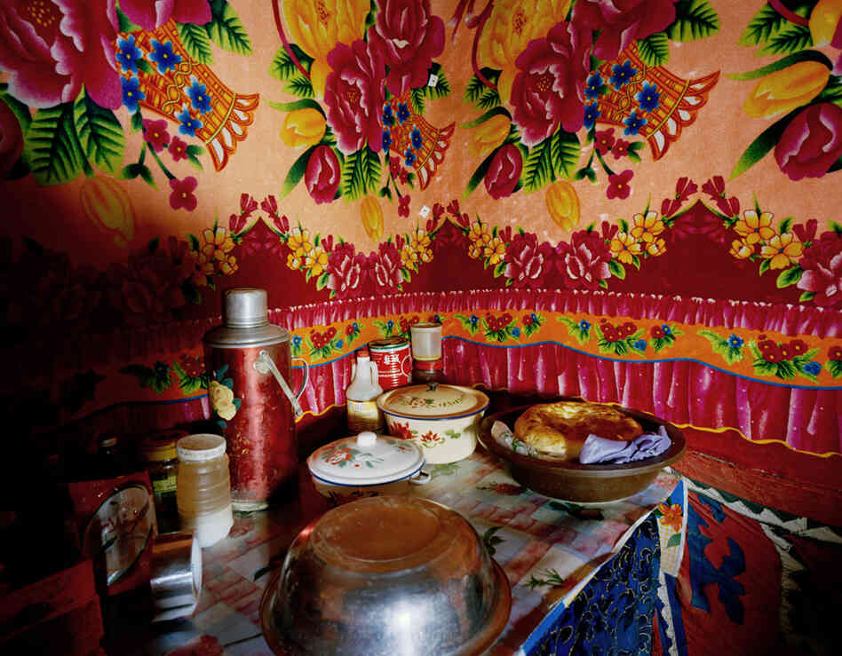 The kitchen inside Jimira's mountain home. Naan and mutton are part of the staple diet of Kyrgyz nomads. There is no running water and no electricity. Firewood stoves are used for cooking and for heating the space.