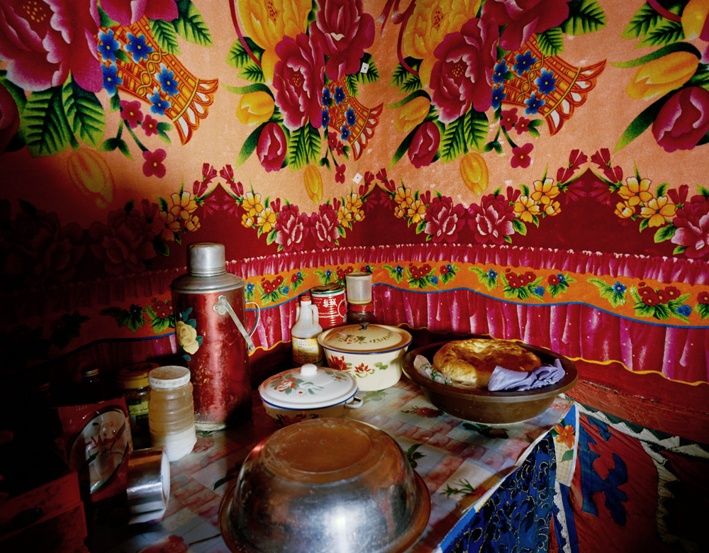 The kitchen inside Jimira's mountain home. Naan and mutton are part of the staple diet of Kyrgyz nomads. There is no running water and no electricity. Firewood stoves are used for cooking and for heating the space.