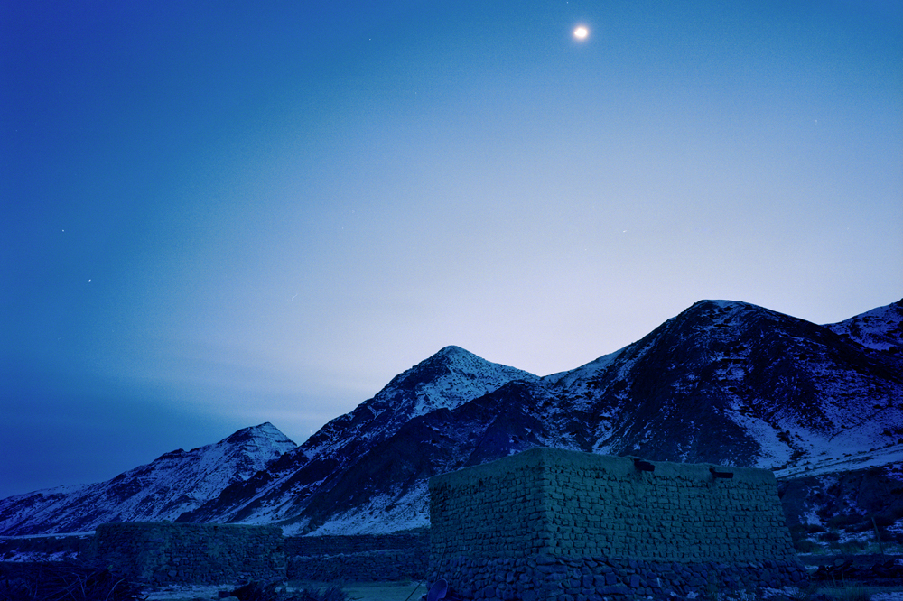 Photographed at dusk, the mud-and-thatch house of Jimira, the third daughter of the Kuruman family, is situated high in the Tianshan mountains.