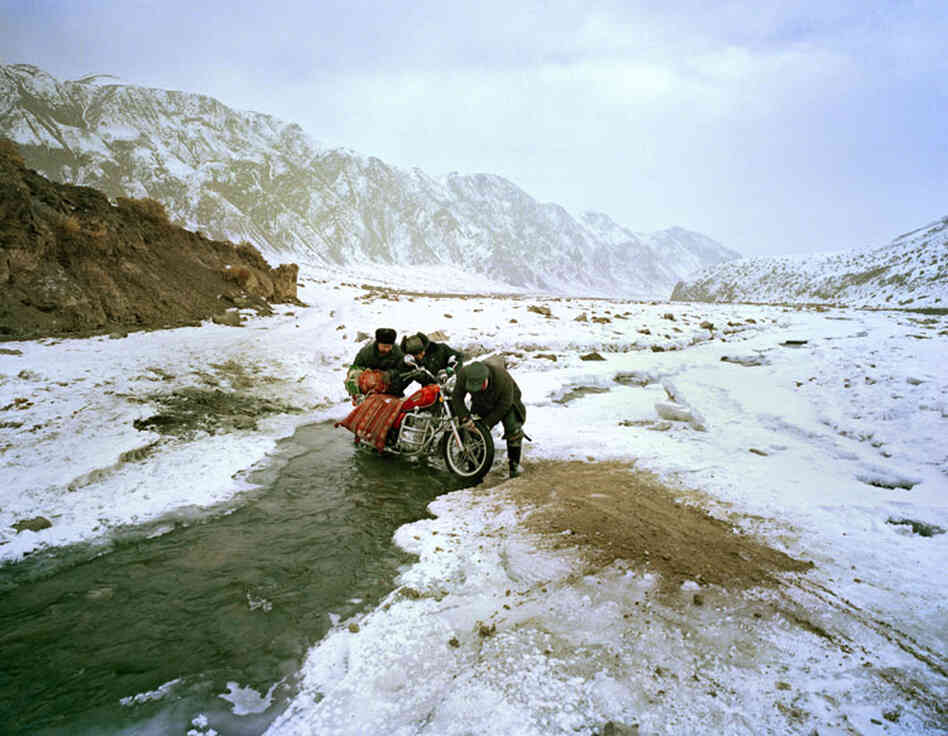 By motorcycle, the trip from the mountains to the town of Wuqiaxian takes 9 1/2 hours through a snowy valley.