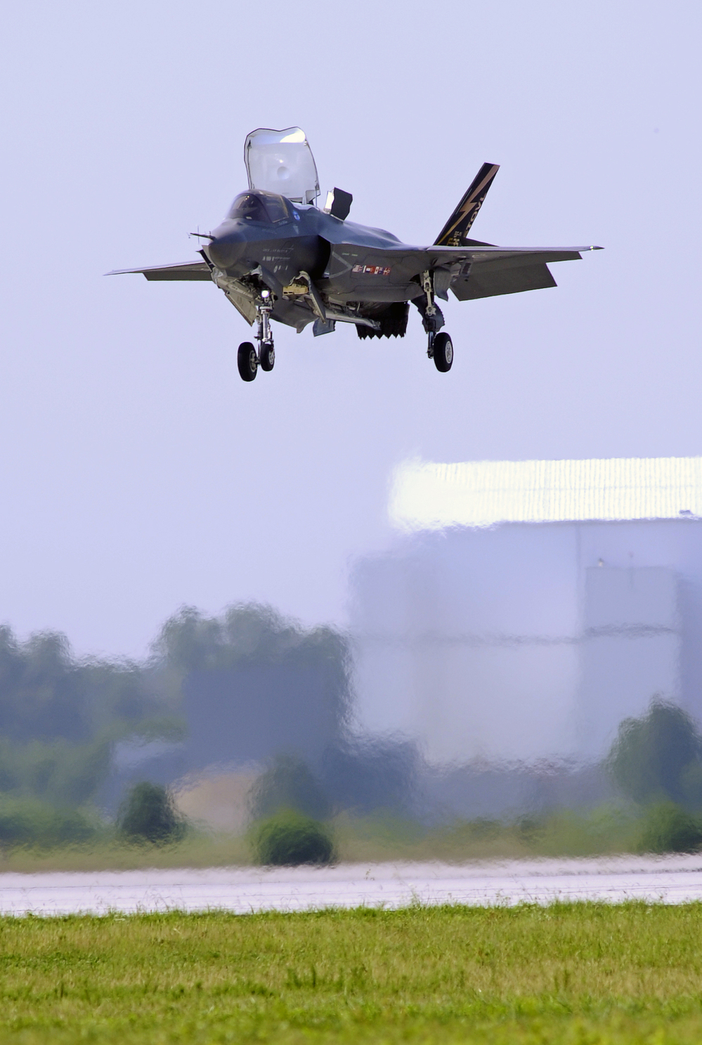 A Marine Corp F-35B Joint Strike Fighter lands at Patuxent Naval Air Station in Maryland in 2011. Analysts say that if mandatory Pentagon budget cuts are imposed next year, fewer new planes could ultimately be ordered.