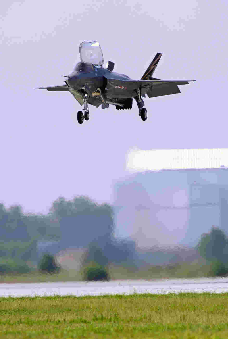 A Marine Corp F-35B Joint Strike Fighter lands at Patuxent Naval Air Station in Maryland in 2011. Analysts say that if mandatory Pentagon budget cuts are imposed next year, fewer new planes could ultimately be ordered.