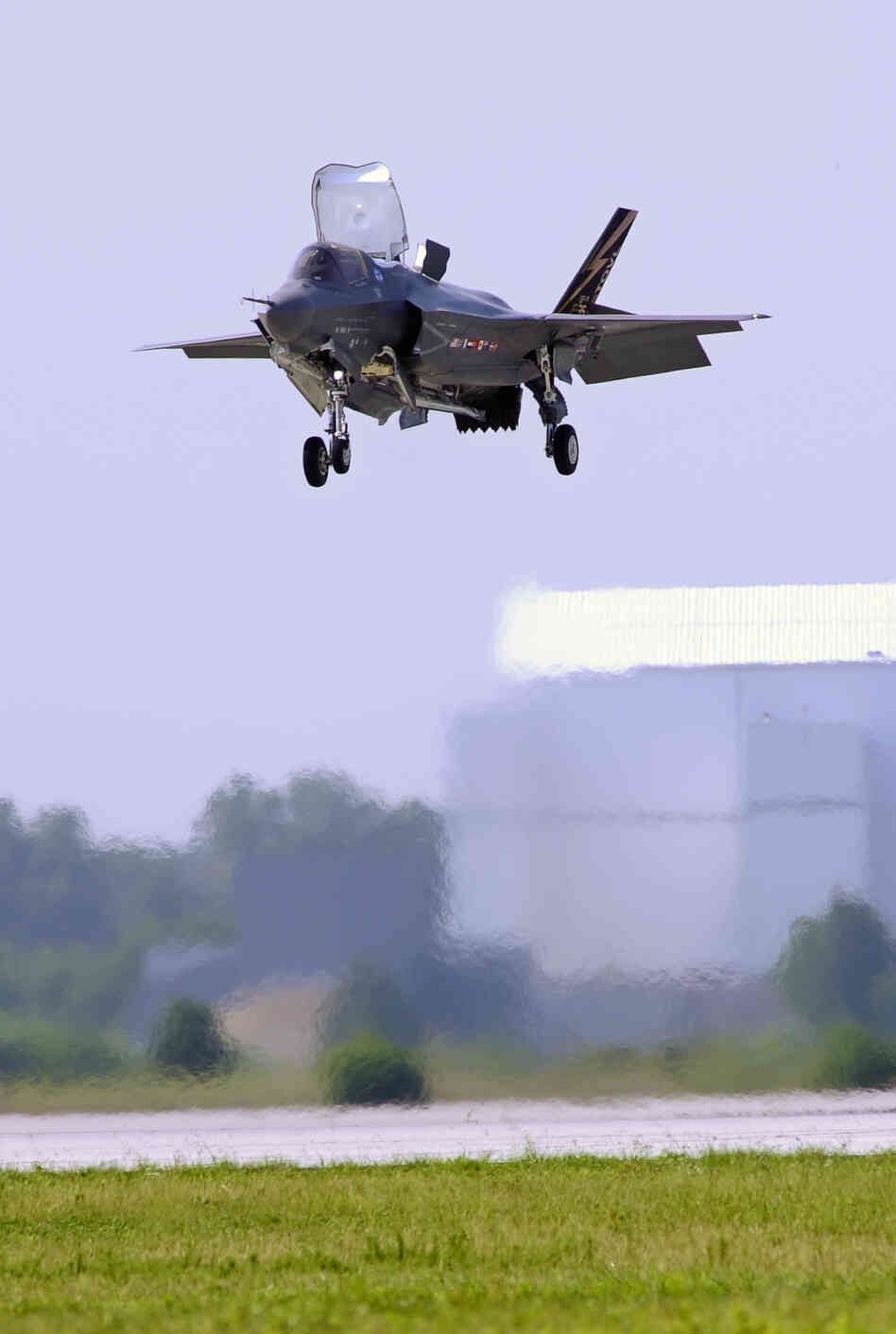 A Marine Corp F-35B Joint Strike Fighter lands at Patuxent Naval Air Station in Maryland in 2011. Analysts say that if mandatory Pentagon budget cuts are imposed next year, fewer new planes could ultimately be ordered.