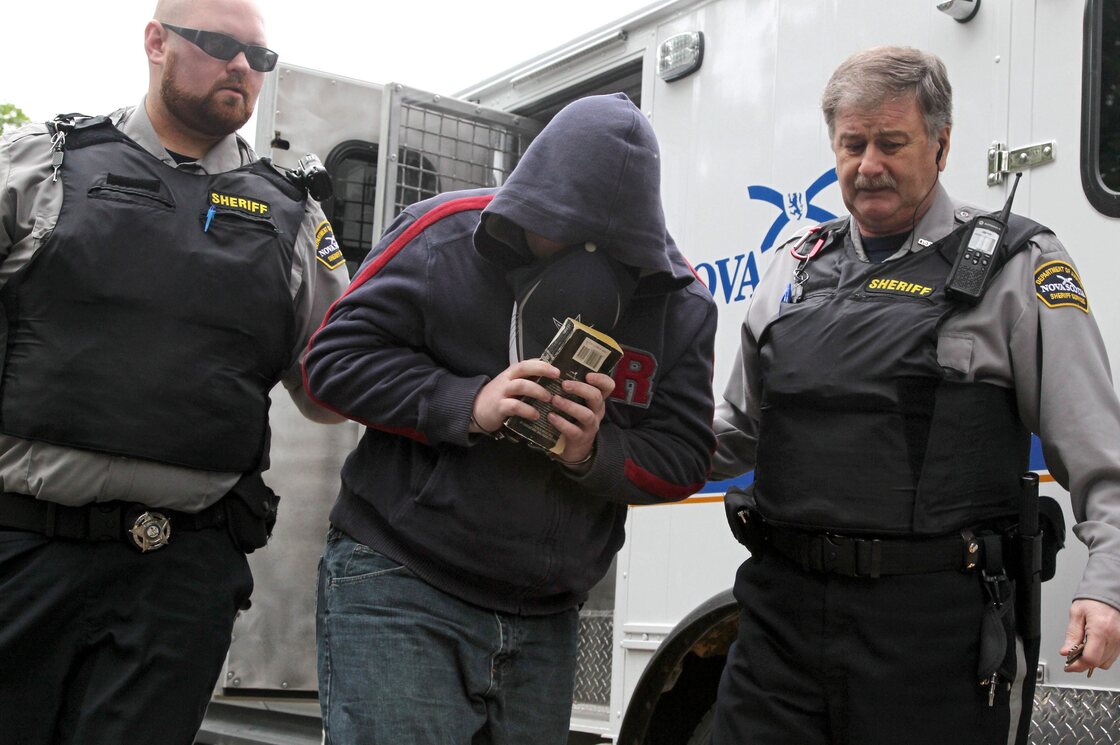 Sub.-Lt. Jeffrey Delisle is escorted into Nova Scotia provincial court in Halifax in June.