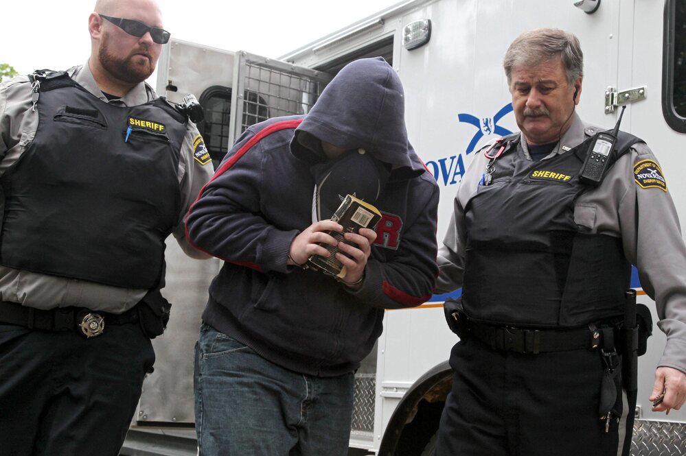 Sub.-Lt. Jeffrey Delisle is escorted into Nova Scotia provincial court in Halifax in June.