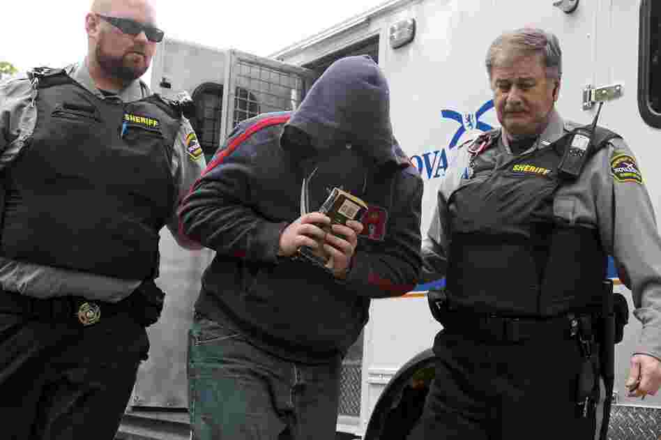 Sub.-Lt. Jeffrey Delisle is escorted into Nova Scotia provincial court in Halifax in June.