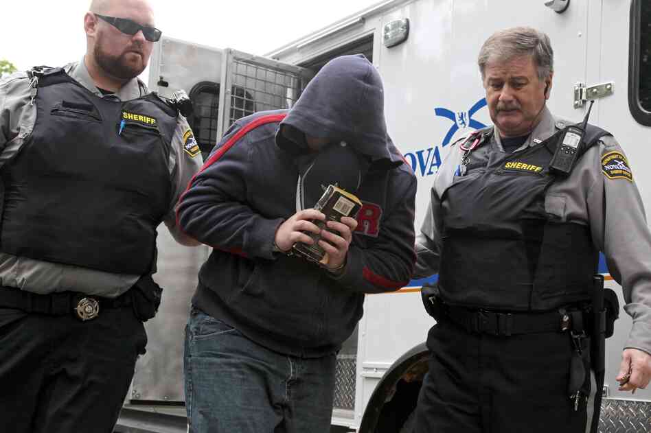Sub.-Lt. Jeffrey Delisle is escorted into Nova Scotia provincial court in Halifax in June.