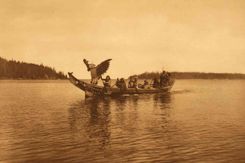 The book caption reads: " ... a masked [Kwakiutl] man personating the thunderbird, dances with characteristic gestures as the canoe approaches the bride's village."