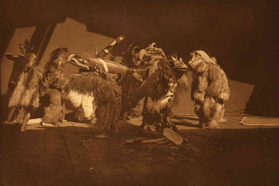 In his book, Curtis identifies this as a Kwakiutl "group of winter dancers." Curtis (and later, his team of photographers) had unprecedented access to sacred ceremonies.