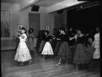 Argentine dancer instructing a group of young women behind her in a dance at Howard University in February 1963.